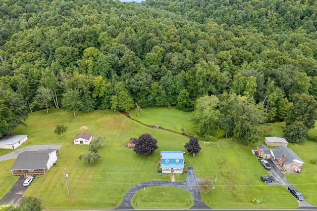 birds eye view of property featuring a view of trees