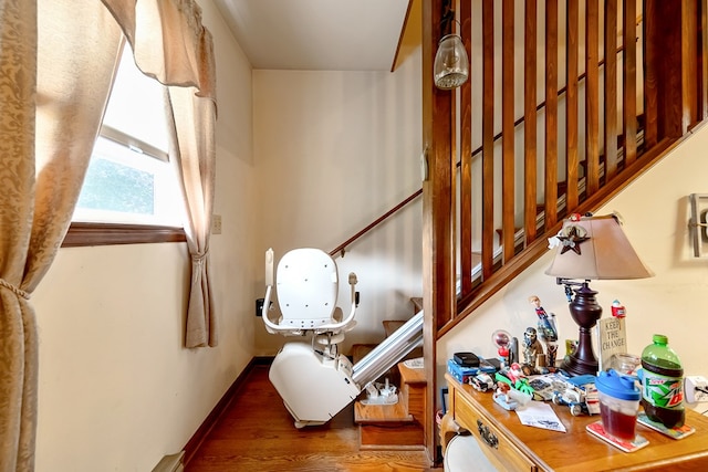 interior space featuring baseboards and wood finished floors