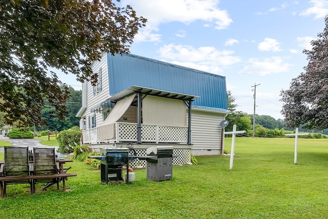 back of property with crawl space and a yard