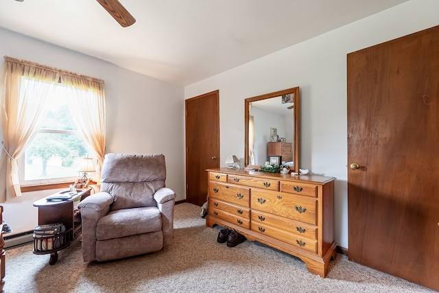 living area featuring carpet flooring, baseboards, and ceiling fan