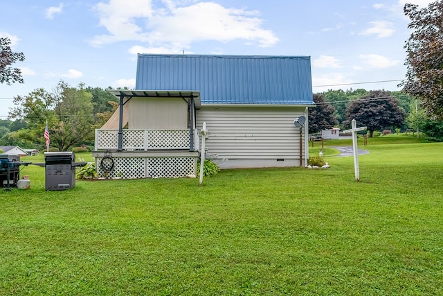 view of home's exterior featuring metal roof, crawl space, and a yard