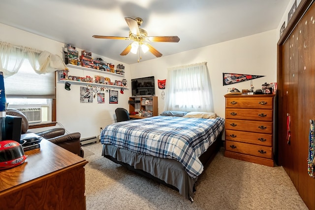 bedroom with a closet, carpet flooring, multiple windows, and a baseboard radiator