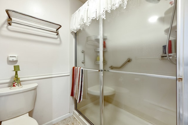 bathroom with toilet and a stall shower