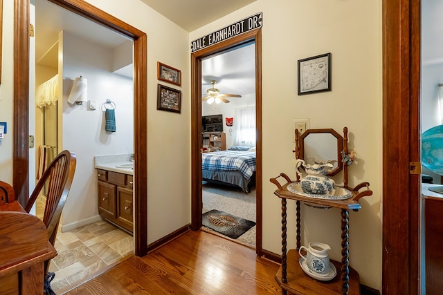 hall featuring baseboards and light wood-style floors