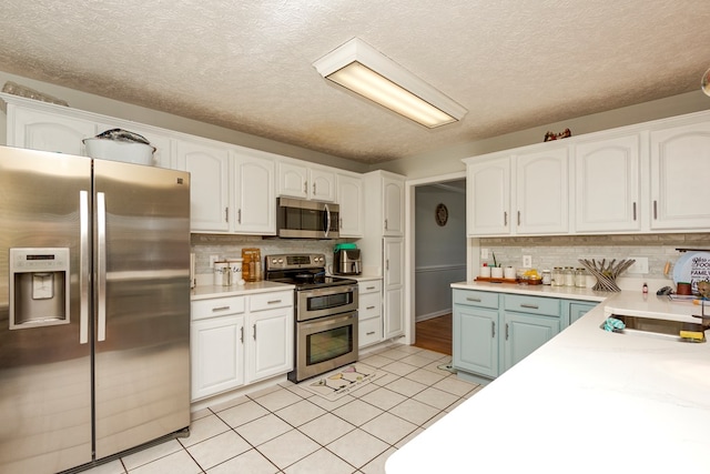 17031 Sedona Dr, Abingdon, VA 24211 - kitchen with stainless steel appliances, white cabinetry, and a textured ceiling