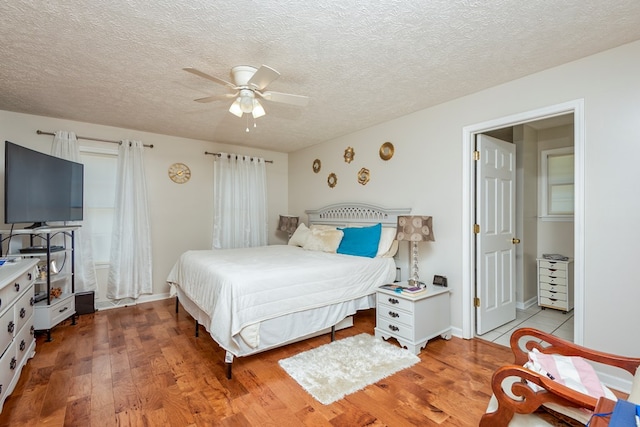 17031 Sedona Dr, Abingdon, VA 24211 - bedroom with wood finished floors, a textured ceiling, and a ceiling fan