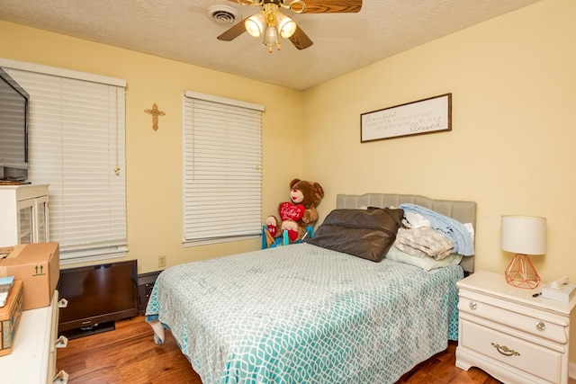 17031 Sedona Dr, Abingdon, VA 24211 - bedroom with wood finished floors, a textured ceiling, and a ceiling fan