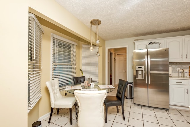 17031 Sedona Dr, Abingdon, VA 24211 - dining space featuring light tile patterned flooring and a textured ceiling