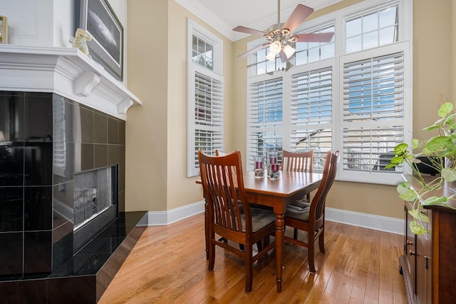 20324 Josh Allen Dr, Abingdon, VA 24211 - dining area featuring ceiling fan, ornamental molding, hardwood / wood-style floors, and a tile fireplace