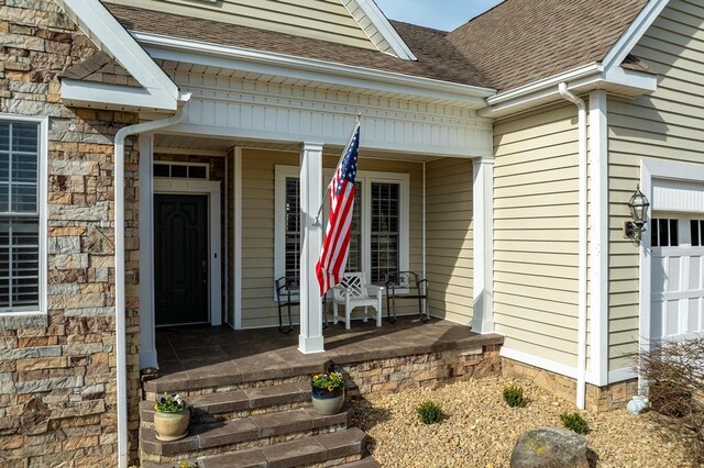 20324 Josh Allen Dr, Abingdon, VA 24211 - view of exterior entry featuring covered porch, a shingled roof, and a garage