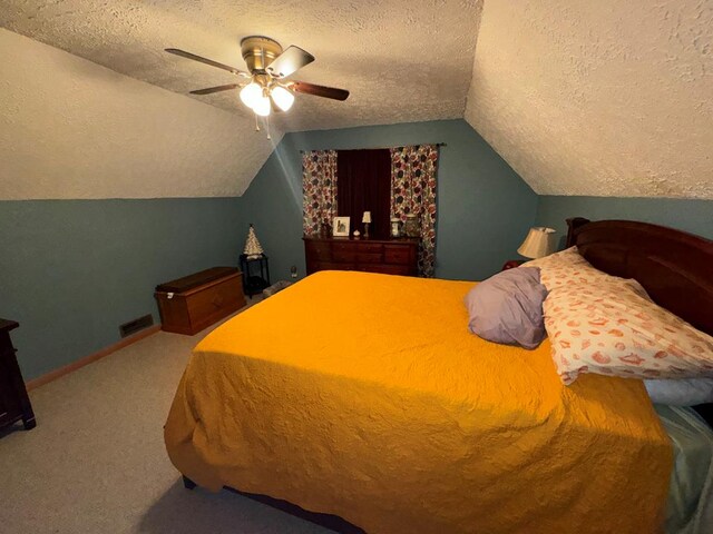 carpeted bedroom featuring a textured ceiling, ceiling fan, and lofted ceiling
