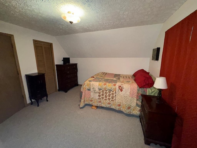 carpeted bedroom with lofted ceiling and a textured ceiling