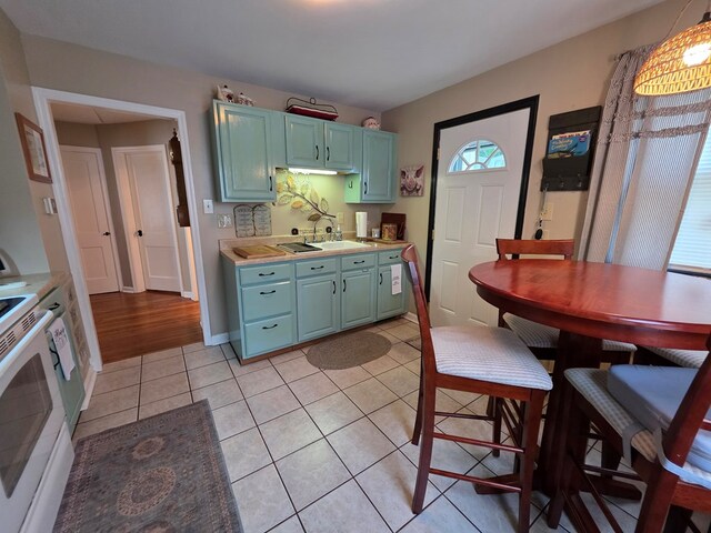 1317 Newton St, Bristol, VA 24201 - kitchen with light countertops, electric stove, and light tile patterned floors