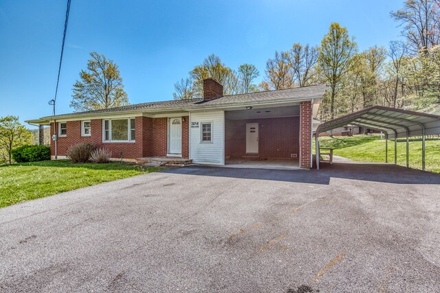 324 Mill Creek Rd, Chilhowie, VA 24319 - ranch-style house featuring a chimney, brick siding, a front lawn, and driveway