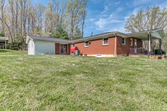 324 Mill Creek Rd, Chilhowie, VA 24319 - back of property featuring a lawn, covered porch, central AC unit, and brick siding