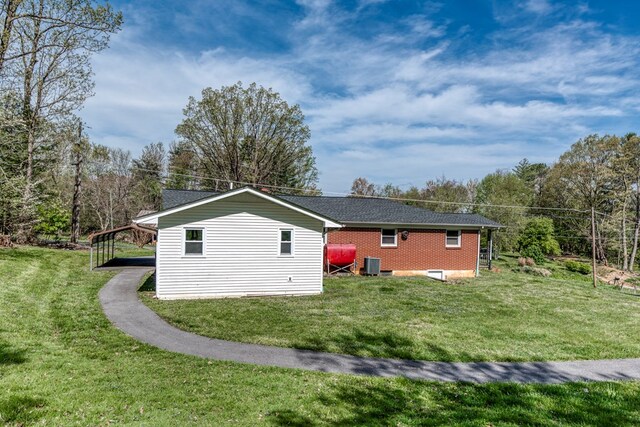 324 Mill Creek Rd, Chilhowie, VA 24319 - view of property exterior featuring a shingled roof, brick siding, cooling unit, and a lawn