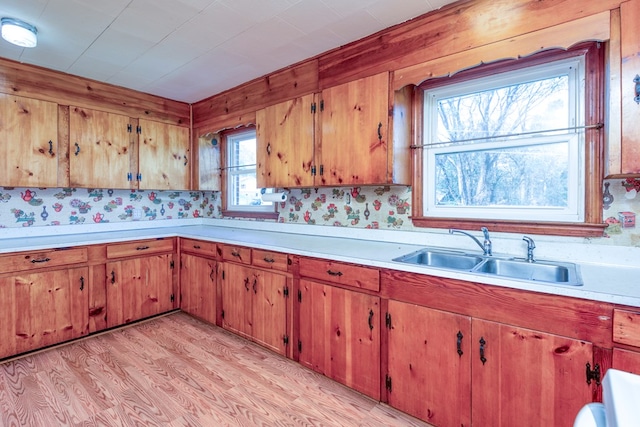 324 Mill Creek Rd, Chilhowie, VA 24319 - kitchen with light wood-type flooring, brown cabinets, light countertops, and a sink