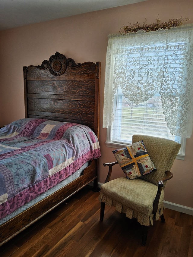 bedroom featuring baseboards and wood finished floors