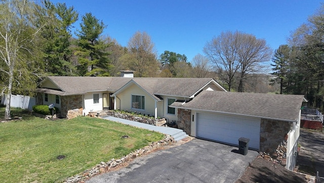 ranch-style house with driveway, stone siding, a chimney, an attached garage, and a front yard
