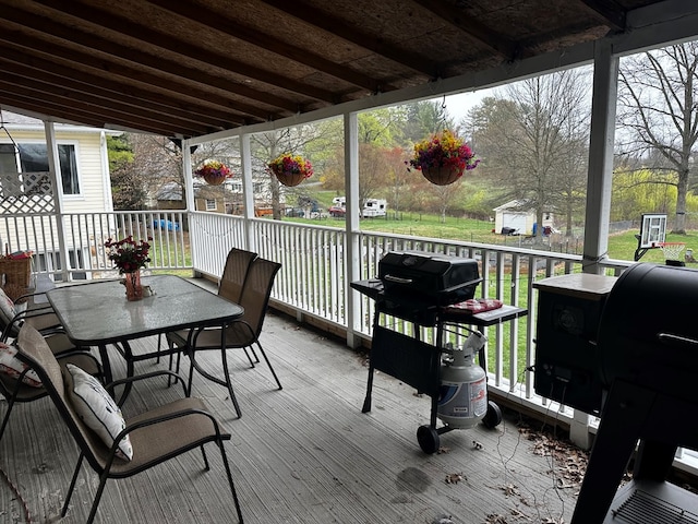 deck featuring outdoor dining area and area for grilling