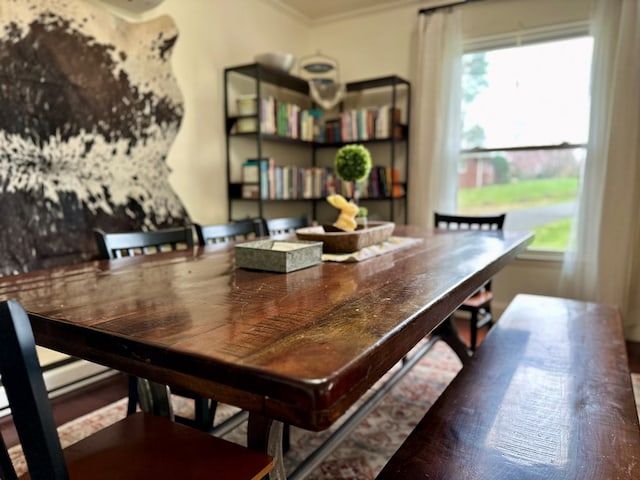 dining area featuring a wealth of natural light and crown molding