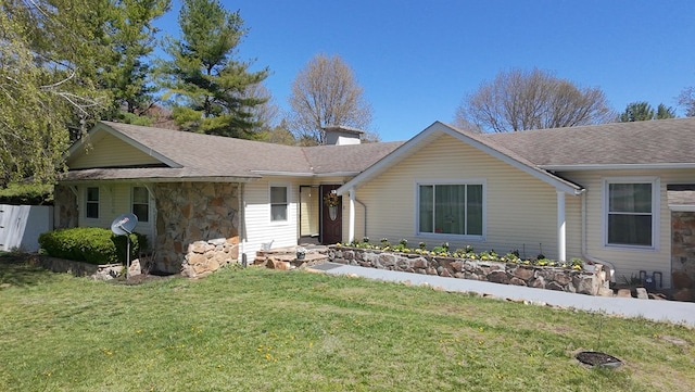 ranch-style house featuring stone siding, a shingled roof, a front lawn, and a chimney