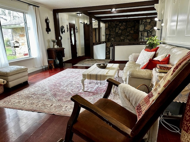 living room featuring a fireplace, wood finished floors, and beam ceiling