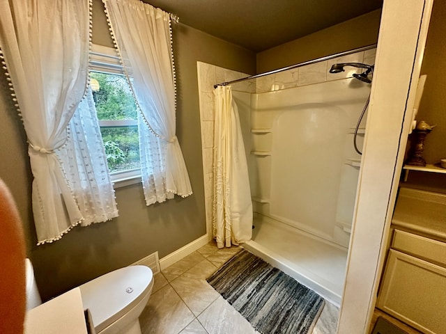 full bathroom featuring toilet and a stall shower