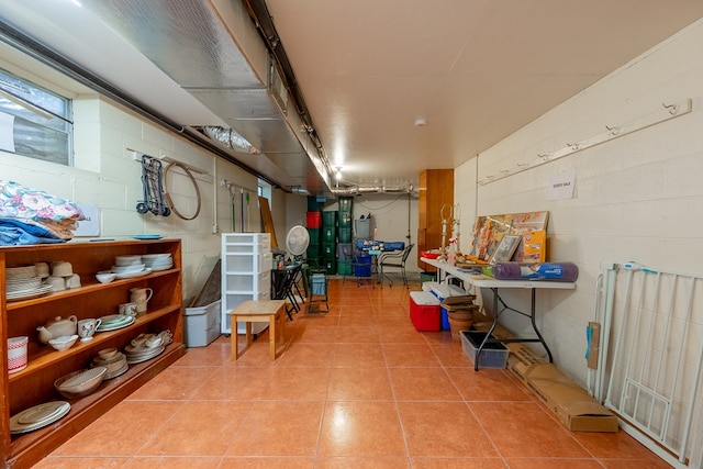 basement with tile patterned flooring and concrete block wall