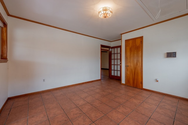 unfurnished room featuring attic access, baseboards, and ornamental molding