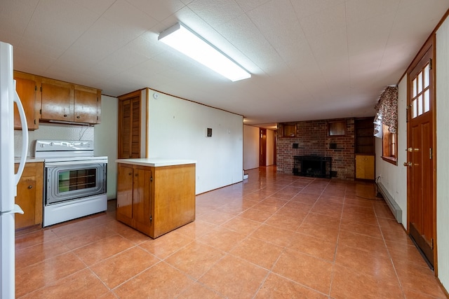 kitchen featuring white appliances, open floor plan, a fireplace, and light countertops