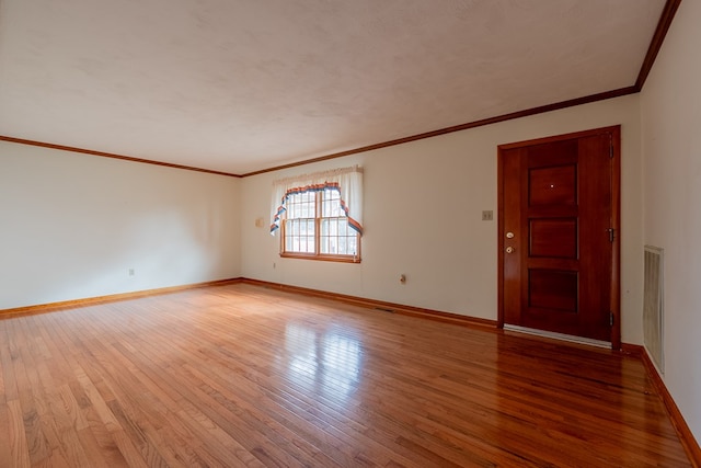 spare room with light wood-style flooring and baseboards