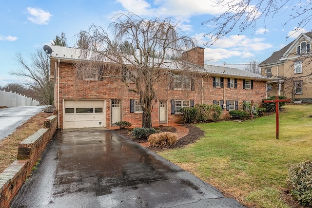 view of front of home with a front lawn, fence, aphalt driveway, a chimney, and an attached garage