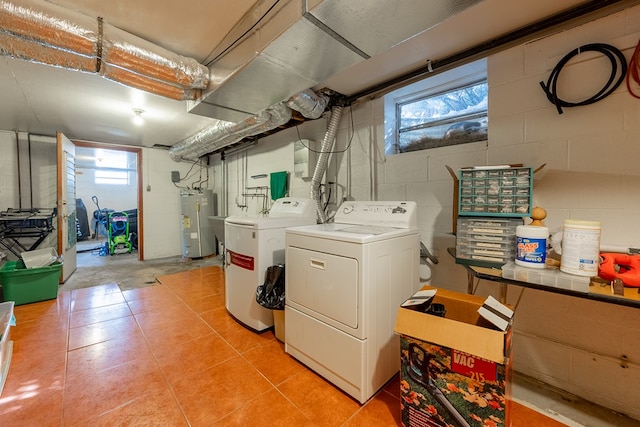 clothes washing area featuring laundry area, independent washer and dryer, and electric water heater