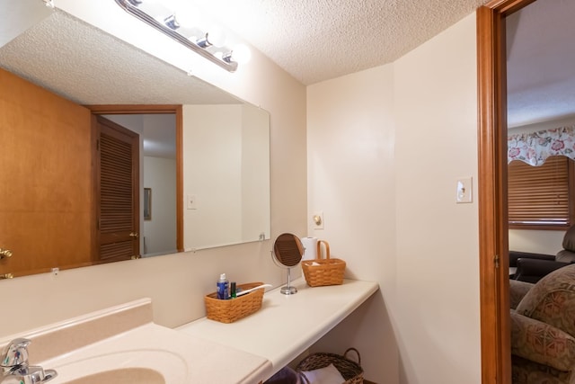 bathroom with vanity and a textured ceiling