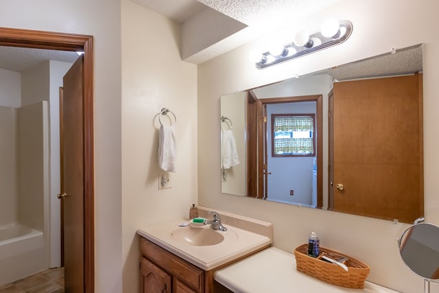 bathroom featuring vanity and a textured ceiling