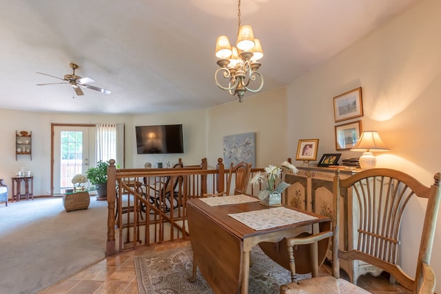 carpeted dining room with ceiling fan with notable chandelier