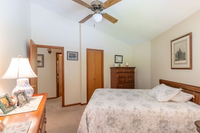 bedroom with vaulted ceiling, light colored carpet, a closet, and ceiling fan