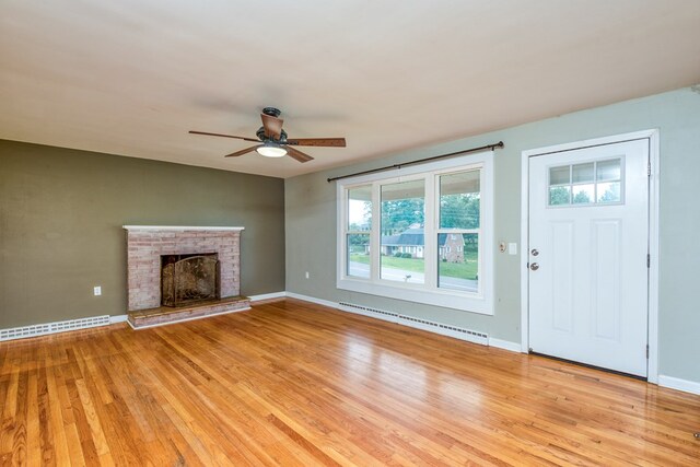 583 Fowler St, Marion, VA 24354 - unfurnished living room with a baseboard radiator, a ceiling fan, light wood-style flooring, and a fireplace