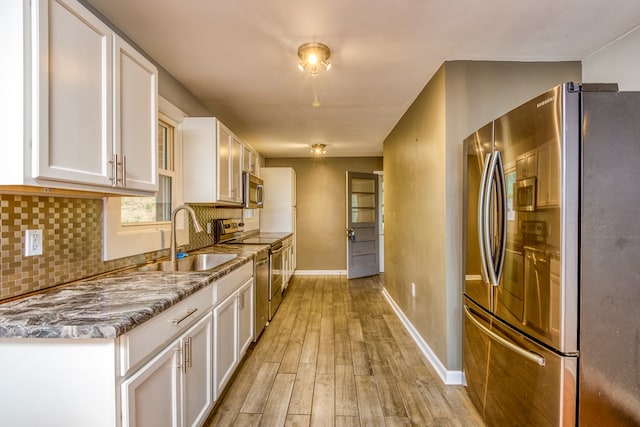 583 Fowler St, Marion, VA 24354 - kitchen with stainless steel appliances, white cabinetry, decorative backsplash, and light wood-style floors