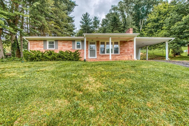 583 Fowler St, Marion, VA 24354 - view of front of house with a front lawn, a chimney, a carport, brick siding, and asphalt driveway