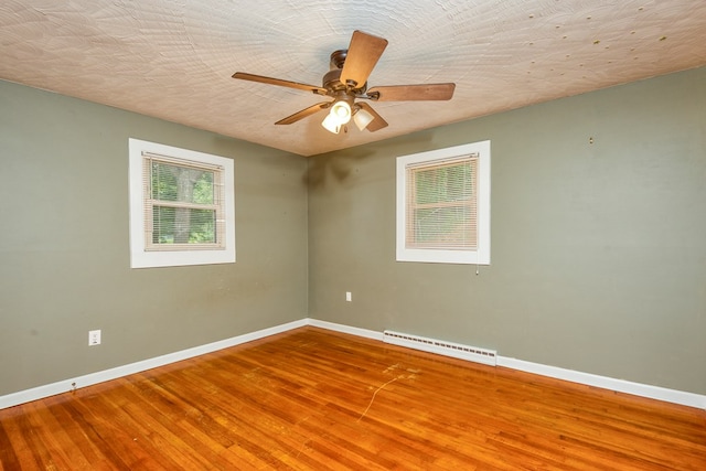 583 Fowler St, Marion, VA 24354 - unfurnished room with wood finished floors, a ceiling fan, and a baseboard radiator