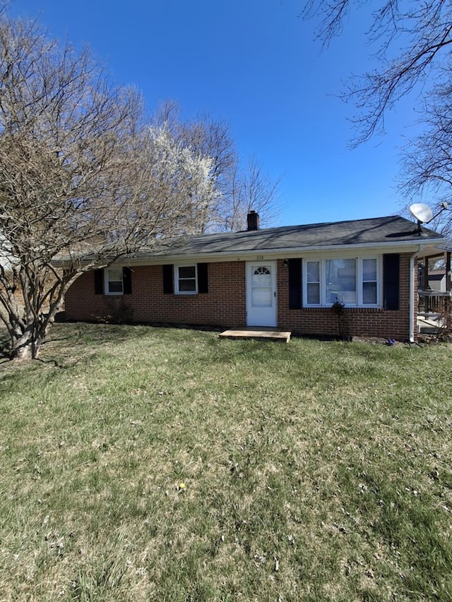 ranch-style house with brick siding and a front lawn