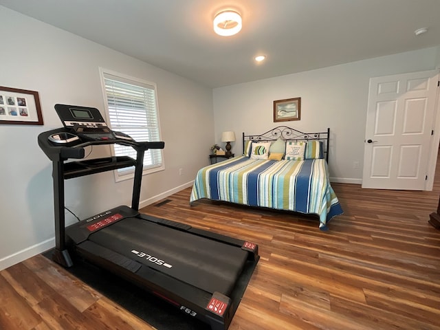 bedroom with baseboards and wood finished floors