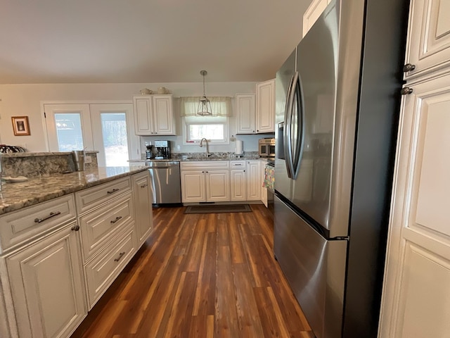 kitchen featuring white cabinets, dark wood-style flooring, appliances with stainless steel finishes, and a sink