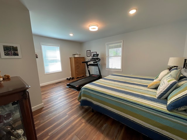 bedroom with recessed lighting, baseboards, dark wood-style floors, and multiple windows