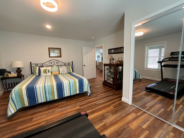 bedroom with baseboards and wood finished floors