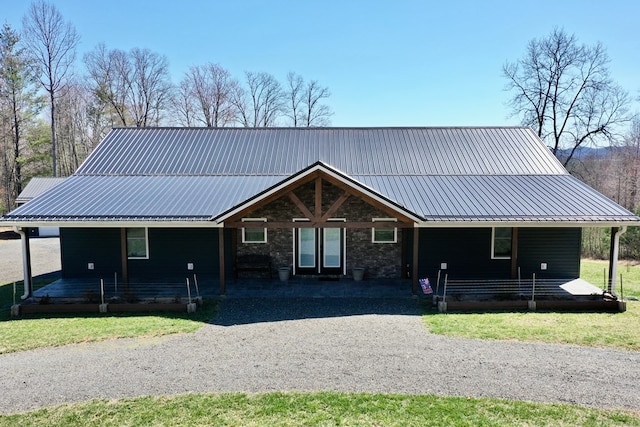 farmhouse inspired home featuring french doors, a porch, and metal roof