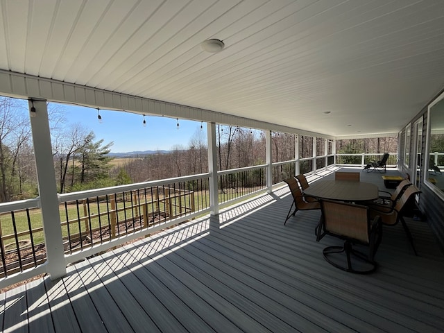 wooden terrace with outdoor dining space