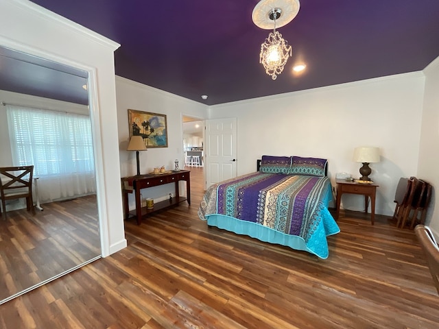 bedroom with crown molding, baseboards, and wood finished floors
